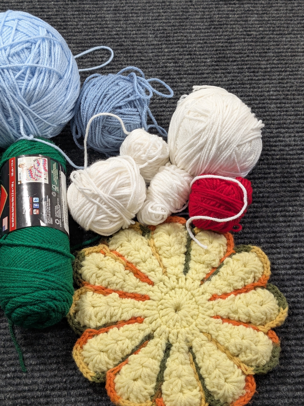 Source Unknown Yellow Crochet Flower Trivet with Orange and Green Edging